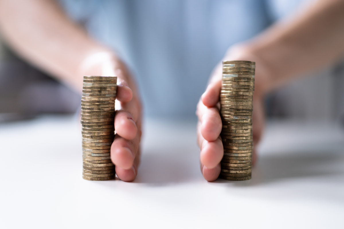 How to Divide 401(k)s and Pensions in Divorce person splitting two piles of coins