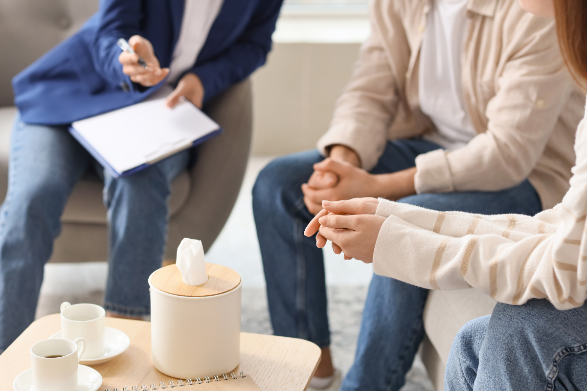 When Mediation Fails What Happens Next in Divorce and Custody Cases two people with a mediator sitting on chairs around a coffee table with tea